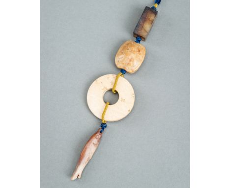 A GROUP OF FOUR JADE PENDANTS, c. 1920sChina, late Qing Dynasty (1644-1912) to Republic period 1912-1949). The four jades str
