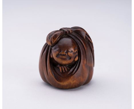 A WOOD NETSUKE OF HOTEI AND A BOY INSIDE HIS TREASURE BAGJapan, 19th century The wood netsuke depicting the lucky god Hotei, 