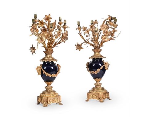 A LARGE PAIR OF FRENCH ORMOLU CANDELABRA  LATE 19TH OR EARLY 20TH CENTURY  Each with blue ceramic body supporting gilt floral