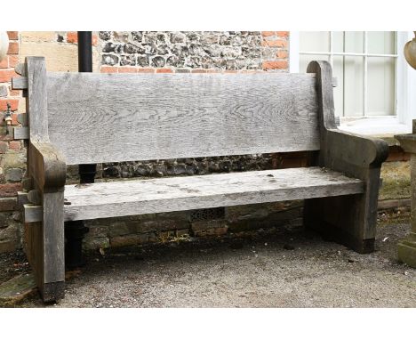A LARGE ENGLISH OAK GARDEN BENCH  MODERN  With pegged tenon joints in the Arts and Crafts manner  202cm wide, 106.5cm high, 6