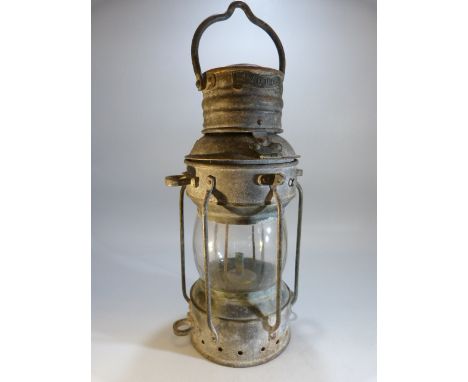Metal ships lamp with brass label 'Anchor' 
