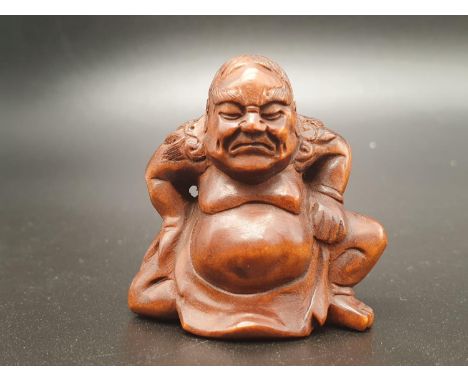 An intricately carved boxwood netsuke of a Sumo wrestler on a ceremonial pose. Signed at the bottom (literally). Height: 4.5 