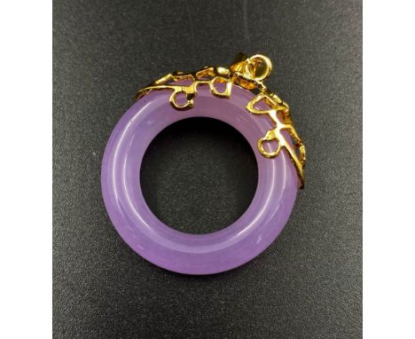 A lavender jade circular pendant with gold metal design work. Diameter 29mm 