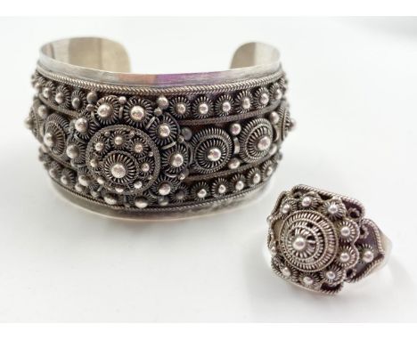 STERLING SILVER BANGLE AND RING SET WEIGHS A COMBINED WEIGHT OF 61.8G AND THE RING IS ADJUSTABLE IN SIZE. 