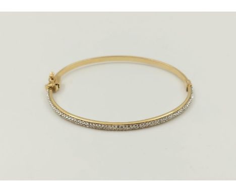 A 9K Yellow Gold Half Eternity Diamond Bangle.6cm diameter. 3.7g 