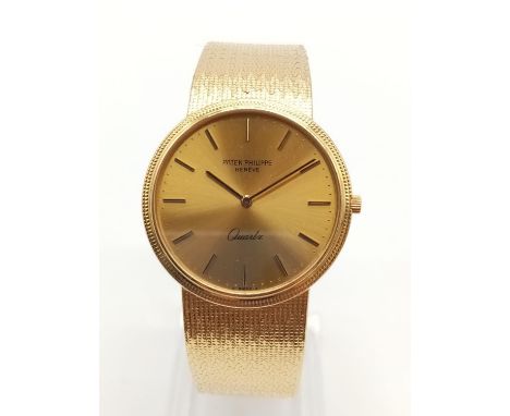 18K gold Patek Philippe Geneve quartz watch with solid gold strap, 34mm case Weight: 82g 