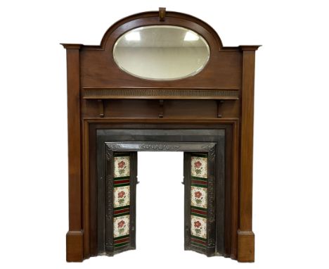 Early to mid-20th century mahogany fire surround, stepped arched top with oval bevelled mirror, fitted with shelf with fluted