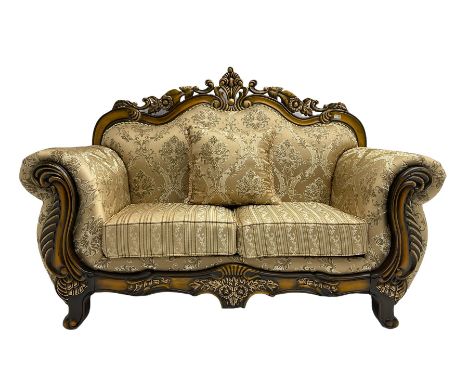 Italian Baroque design two seat sofa, hardwood framed, the cresting rail carved and pierced with c-scrolls and flower heads, 