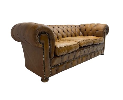 Chesterfield three seat sofa, upholstered in buttoned tan leather with studded detail, on turned feetDimensions: Height:&nbsp