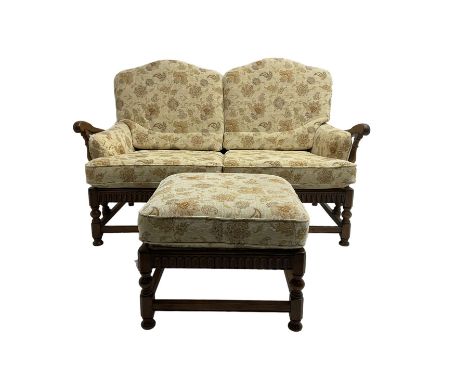 Ercol elm two seat sofa (W155cm, D100cm, H100cm), and matching footstool (60cm x 60cm, H44cm), loose cushions upholstered in 