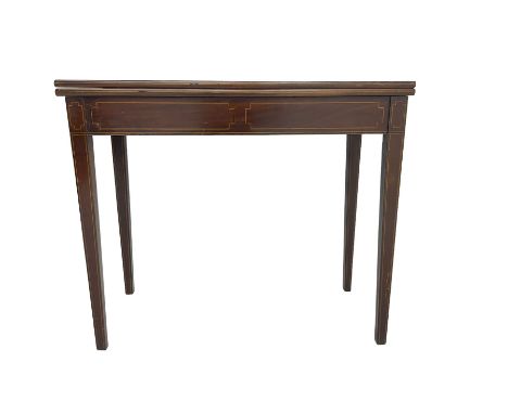 Early 19th century mahogany card table, rectangular fold-over top, the frieze inlaid with boxwood stringing, on square taperi