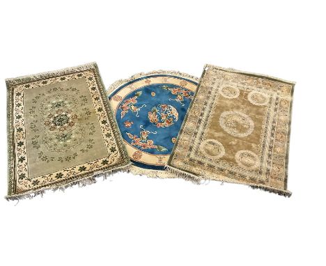 Three Chinese washed woollen rugs - circular blue ground decorated with dragons (D54cm), rectangular light green rug (185cm x