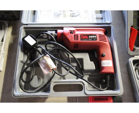 A Powerdevil hammer drill in fitted plastic case with instruction manual