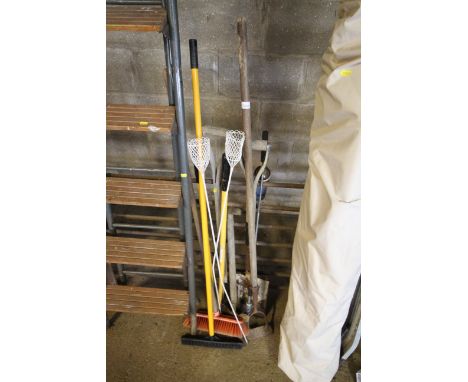A quantity of long handled garden tools to include hoes, spades, brushes etc.