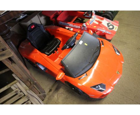 A child's Rastar electric car in the shape of a red Lamborghini (lacking key and charger)