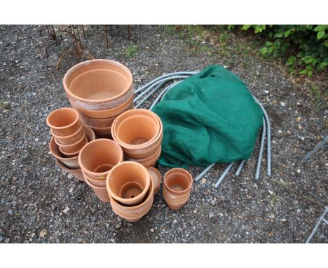A quantity of various sized terracotta plant pots together with a vegetable patch frame