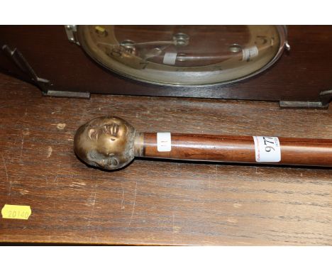 A walking stick with four sided Buddha's head handle (11)