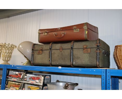 A vintage suitcase, a travelling truck, a table lamp and shade