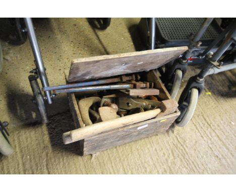 A wooden storage box and contents of tools to include hand axe, two pairs of stilsons, smoothing plane, shoe last etc. 