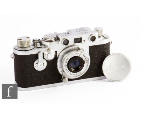 A Leica IIIf, circa 1956, with Leitz Elmar F1:3.5 50 lens, ‘Red Dial’, chrome body, serial number 814916. 