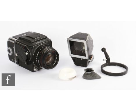 A Hasselblad 500 C/M medium format camera, serial number RS 1236043 (1980), film back serial number TR 118815 (68) fitted wit