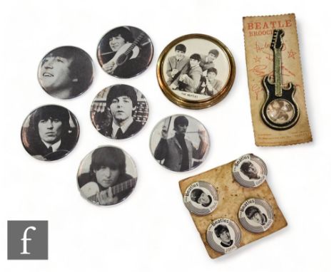 A collection of original 1960s Beatles related items, to include a compact, a set of four carded badges, a carded guitar broo