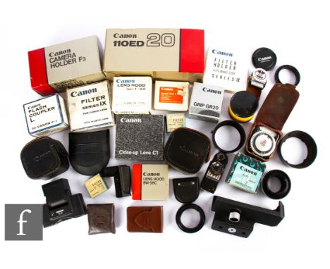 A collection of Canon accessories, to include boxed camera holder F3, boxed 110ED 20, lens hoods, filters, lens caps, light m