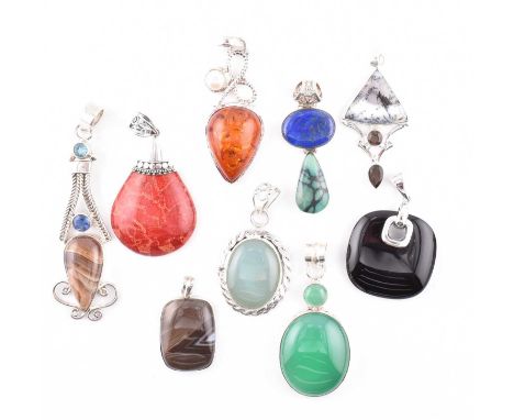 A quantity of silver white metal and gem set necklace pendants. The nine necklace pendants to include onyx with product card,