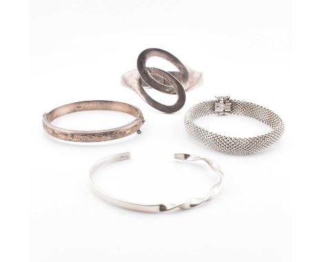 A collection of silver bangles and bracelets. The lot to include a hallmarked silver mesh link bracelet with concealed box cl