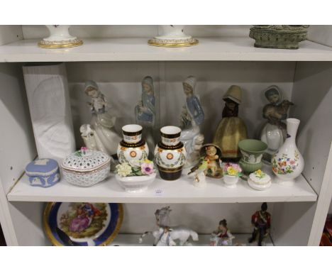 A shelf of decorative china to include Lladro and Rosenthal.