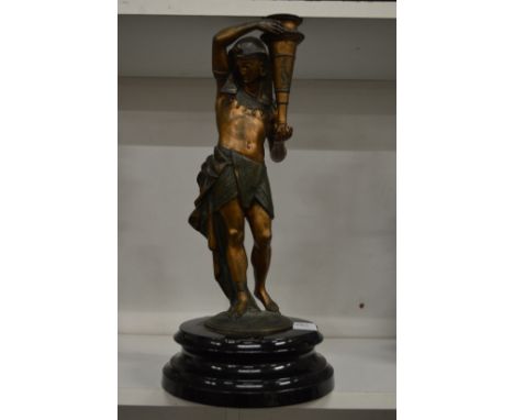 A spelter lamp base modelled as an Egyptian man holding a torch.
