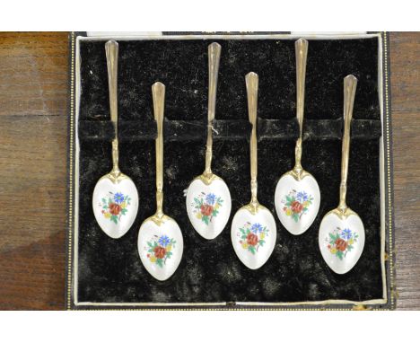 A set of six silver and enamel backed coffee spoons.