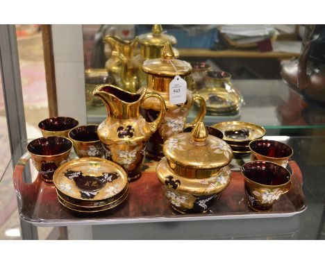 A decoratively painted and gilded ruby glass tea service.