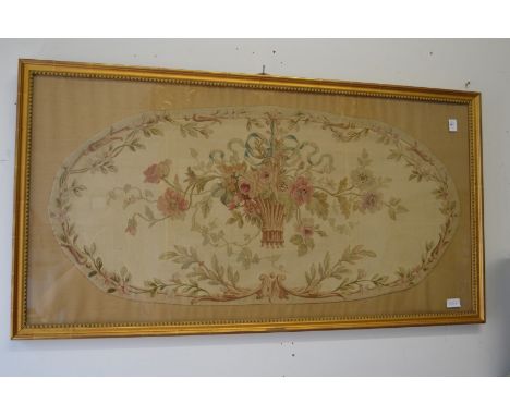 An Aubusson style tapestry picture of a basket of flowers, decoratively gilt framed and glazed.