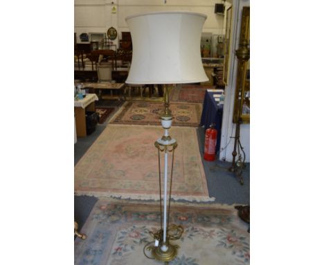 An ornate Adam revival floor standing lamp with shade.