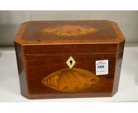 A Georgian mahogany tea caddy with shell inlaid decoration.