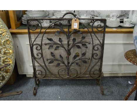 A heavy wrought iron fireguard.