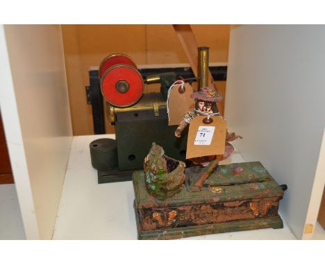 A cast iron money bank and a steam engine.