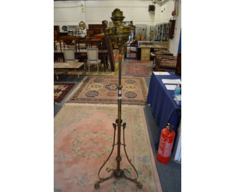 An ornate brass floor standing oil lamp.