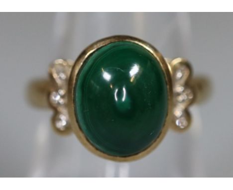 Green cabouchon set gold dress ring with diamond chip shoulders.  Unmarked.  5.4g approx size M.  (B.P. 21% + VAT) 