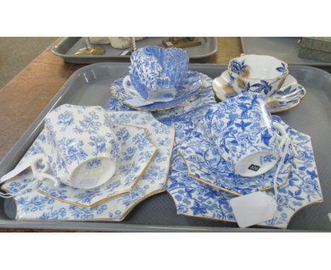 Three Late 19th century Wileman trios and a Foley China, daisy shaped, cup and saucer decorated with blue peonies and gilt sp