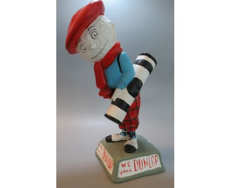 A Dunlop Caddy Golf ball Advertising Figure on naturalistic base, inscribed 'We play Dunlop'  37cm high approx.  (B.P. 21% + 