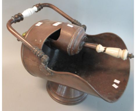 Victorian copper helmet shaped coal scuttle with swing and ceramic handle together with a matching shovel.  (B.P. 21% + VAT) 