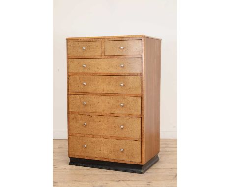 An Art Deco-style burr maple and teak chest of drawers,1950s, with two short and five graduated drawers, fitted with chrome b