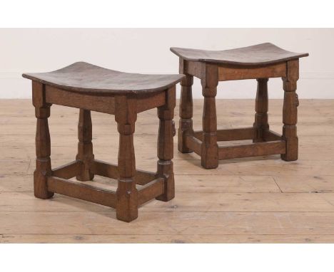 A pair of Robert 'Mouseman' Thompson burr oak stools,1930s, each with an adzed and dished burr oak seat, nailed to the octago