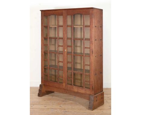 Sidney Barnsley (1865-1926),a Cotswold oak bookcase, the carcass of thorough dovetail construction, fitted with a pair of bar