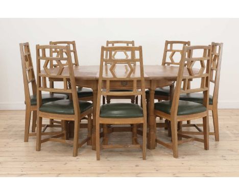 A Yorkshire School 'Cowman' dining suite, comprising: an extending dining table, raised on six turned and chamfered supports,