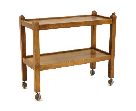 A Robert 'Mouseman' Thompson oak trolley, 20th century, of rectangular form, the two tiers raised on square section supports,