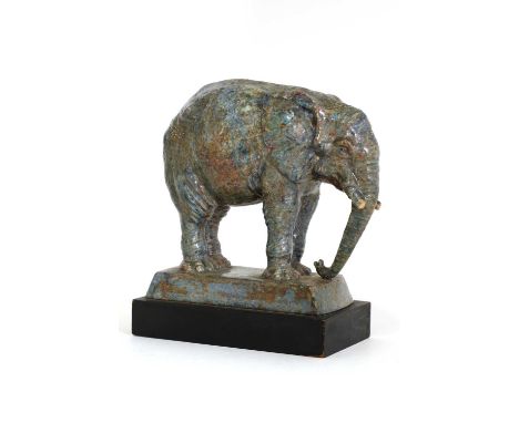 A glazed stoneware figure of an elephant,dated 1923, by Harry Parr, inscribed to the base 'HY PARR 1923 CHELSEA', on an eboni