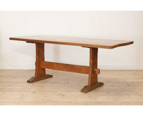 A Yorkshire School oak dining table,by Robert 'Kingpost' Ingham, with a four-plank adzed top with chamfered edges, raised on 